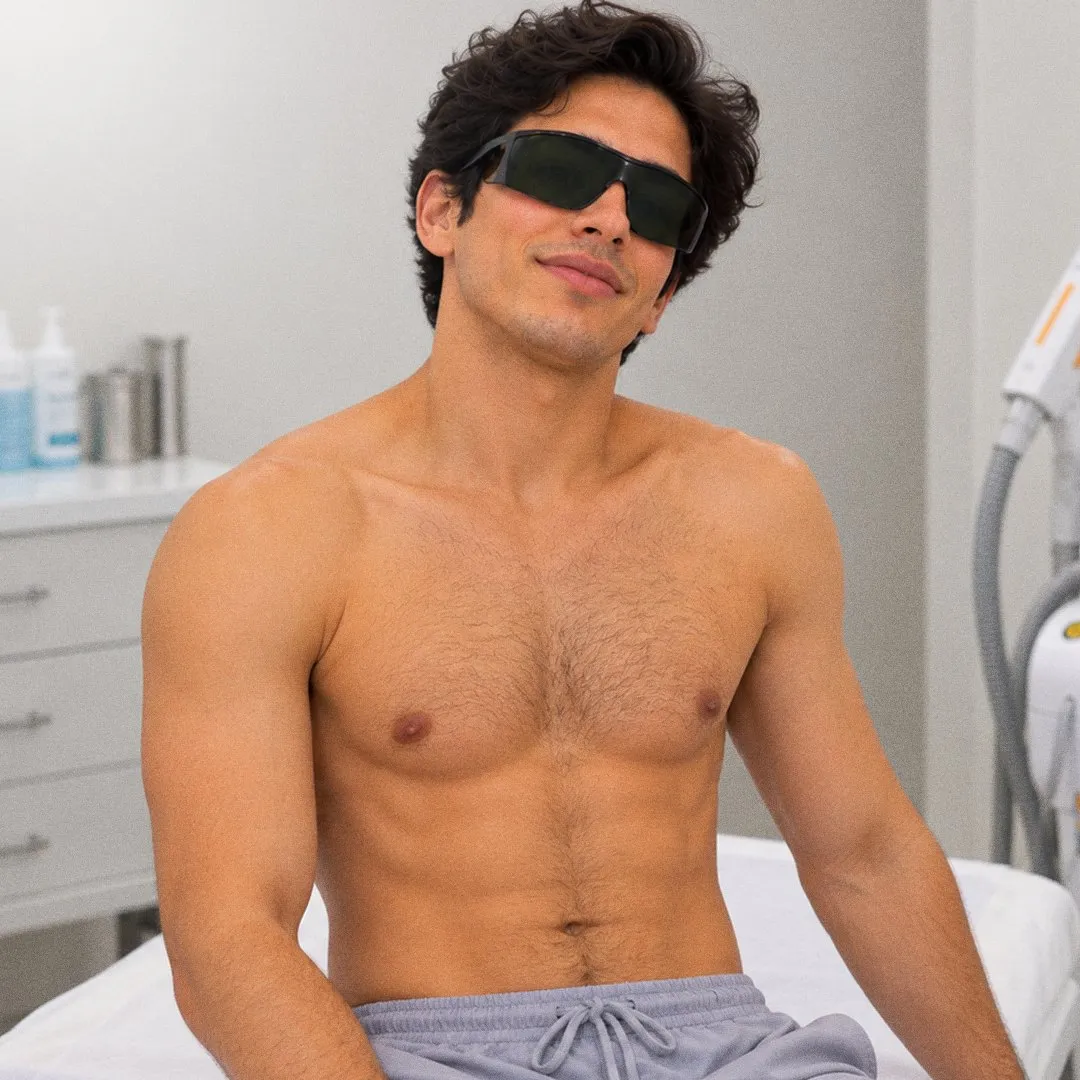 Cliente sentado en la camilla con el pecho y el abdomen depilados